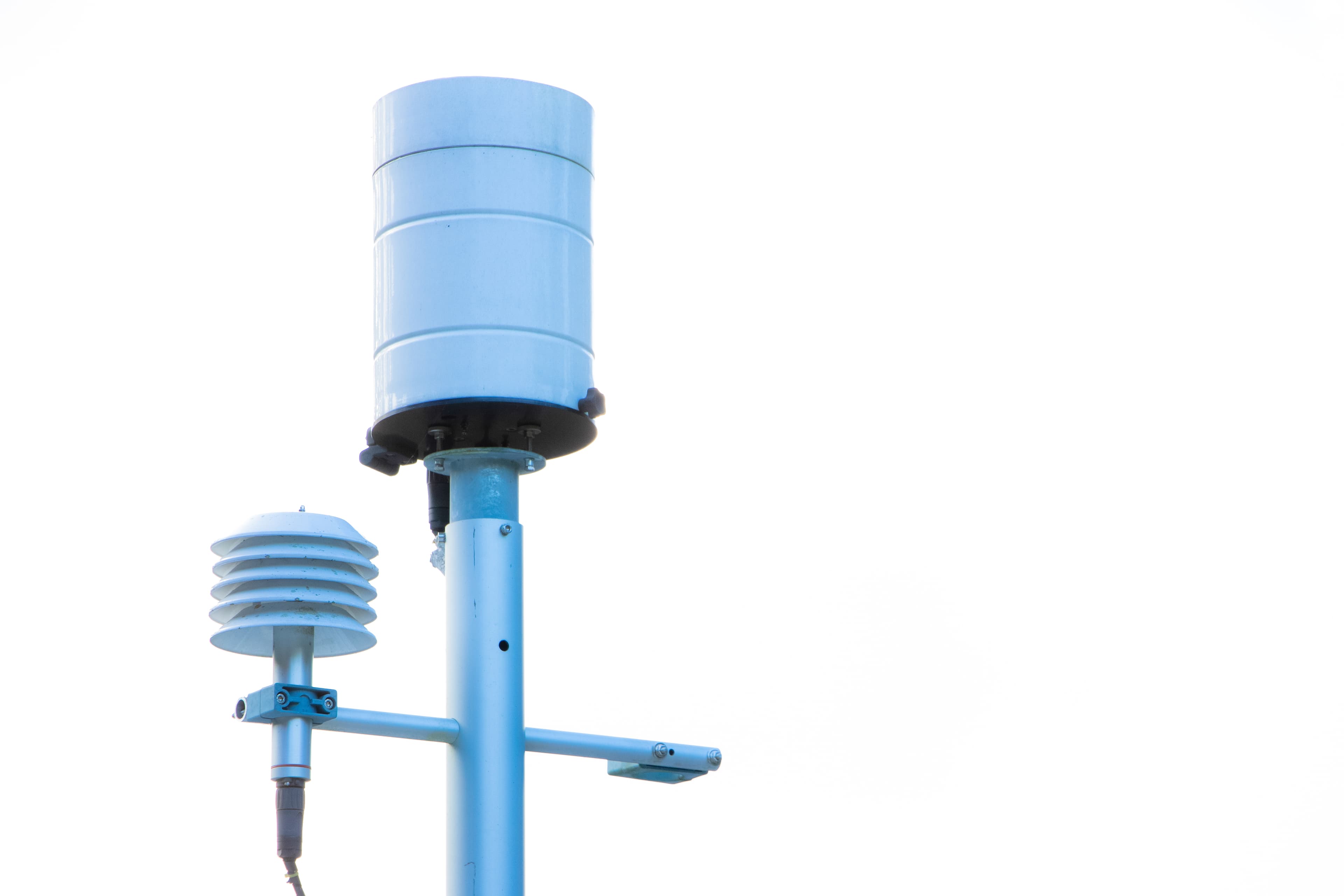 Rain gauge and radiation shield on an automatic weather station